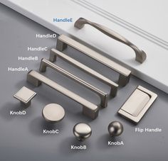 an assortment of handles and knobs on a gray surface with labels labeled in english