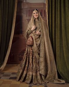 a woman in a bridal outfit posing for a photo with curtains behind her and the curtain