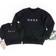 These matching sweatshirts are the perfect addition for any mama wanting to do matching mommy an daughter outfits or matching mom and son shirts. Make it extra special by adding your own custom names! *Grey sweatshirts are printed with black text ♥ABOUT OUR SWEATSHIRTS: Uptown Studio Designs uses a unisex adult Gildan brand sweatshirt. This unisex sweatshirt is preshrunk and has a classic fit. Consider ordering your regular size for a standard fit or size up if you want a roomier option. A sturd Customizable Long Sleeve Family Matching Sweatshirt, Mother's Day Black Crew Neck Sweatshirt, Family Matching Graphic Print Sweatshirt, Family Matching Cotton Winter Tops, Customizable Family Matching Crew Neck Sweatshirt, Personalized Cotton Sweatshirt For Family, Personalized Cotton Family Sweatshirt, Family Matching Long Sleeve Sweatshirt With Name Print, Family Matching Long Sleeve Letter Print Tops