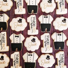 decorated cookies are arranged in the shape of grooms and bridesmaid suits with names on them