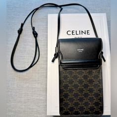 Pristine Condition With Dust Bag, Tags, And Box. Celine Phone Pouch With Two Card Slots For Credit Cards And Id. Leather Adjustable Straps. Luxury Phone Bag With Dust Bag For Daily Use, Luxury Black Phone Bag With Detachable Strap, Luxury Brown Mobile Phone Bag, Designer Rectangular Phone Bag For Travel, Designer Rectangular Travel Phone Bag, Designer Mobile Phone Shoulder Bag For Formal Occasions, Luxury Crossbody Phone Bag With Removable Pouch, Elegant Brown Phone Shoulder Bag, Elegant Brown Shoulder Phone Bag