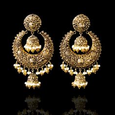 A fun pair with classic deign that never goes out-of-style! Gorgeous pair of earrings that is a perfect pick to pull-off any traditional or ethnic look. With its beautiful metal carving, embossed details and timeless jhumki design with an addition to pearl moti, this pair is all you need for the upcoming events. Kajal Earrings are available in two sizes. Big earrings are about 4.5" long and small earrings are about 3" long. Gold-plated on high-quality brass as base metal. Delivery time frame is Brass Chandbali Bridal Earrings, Elegant Oxidized Brass Hoop Earrings, Elegant Brass Hoop Earrings With Oxidized Finish, Elegant Gold Hoop Earrings With Oxidized Finish, Brass Earrings With Intricate Design For Festivals, Metal Chandbali Hoop Earrings With Intricate Design, Brass Round Earrings With Latkans, Heavy Chandbali Earrings In Brass, Round Brass Earrings With Latkans