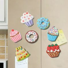 magnets on the side of a refrigerator decorated with donuts and cupcakes