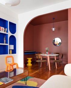 a living room filled with furniture and colorful walls