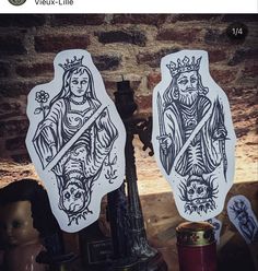 two stickers depicting the virgin mary and jesus on a table with other items in front of them