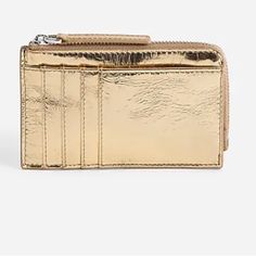 Our Leather Bag And Accessory Collection Is Cool, Modern And Quietly Luxe. This Streamlined Metallic Wallet Has Four Card Slots, A Large Front Slip Pocket And A Top Zip To Secure Loose Change And A Key Or Two. It's So Good, It's Essential. Leather. Zip Closure. Card Holder Pockets. 3"H X 5"W X 2"D. Luxury Gold Coin Purse With Card Slots, Gold Luxury Wallets With Card Slots, Luxury Gold Wallets With Card Slots, Elegant Gold Wallet With Coin Pocket, Gold Bifold Coin Purse For Everyday Use, Everyday Gold Leather Coin Purse, Gold Clutch Bag With Card Slots, Gold Leather Bags With Card Slots, Gold Bifold Wallet For Everyday Use