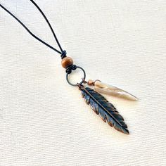 The bohemian feather necklace for men is an authentic piece of Native American jewelry, featuring a unique leather design. This spiritual jewelry also makes an eco-friendly gift for women, with intricate native beading that highlights its cultural significance. 🪶 𝗠𝗔𝗧𝗘𝗥𝗜𝗔𝗟𝗦 + 𝗗𝗜𝗠𝗘𝗡𝗦𝗜𝗢𝗡𝗦 ❯  Leather, wood, shell, metal ❯  Pendant is 3 inches long 🪶 𝗦𝗧𝗢𝗡𝗘 + 𝗘𝗟𝗘𝗠𝗘𝗡𝗧 𝗘𝗡𝗘𝗥𝗚𝗬 ❯  ABALONE is known for its powers of warding off negativity ❯  WOOD symbolizes life, growth and strength ❯  COPPER enhances positive energy flow 🪶 𝗣𝗘𝗥𝗦𝗢𝗡𝗔𝗟𝗜𝗭𝗔𝗧𝗜𝗢𝗡 + 𝗚𝗜𝗙𝗧 𝗦𝗘𝗧 𝗦𝗨𝗚𝗚𝗘𝗦𝗧𝗜𝗢𝗡𝗦 ❯  Abalone Bracelet (photo 6) -- lorenlavinedesigns.etsy.com/listing/641362537 ❯  Custom Engraved Charm (photo 8 + 9) -- lorenlavinedesigns.etsy.com/listing/1773821992 ? Black Bohemian Necklace For Everyday Use, Black Bohemian Necklace For Everyday, Adjustable Feather Necklace As Gift, Adjustable Bohemian Necklaces With Feathers, Bohemian Brown Feather Jewelry, Abalone Bracelet, Bohemian Style Men, Native Beading, Abalone Necklace