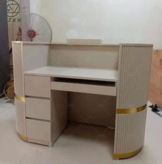 an office desk made out of cardboard with a fan on top