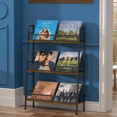 a book shelf with several books on it in front of a blue wall and wooden floor