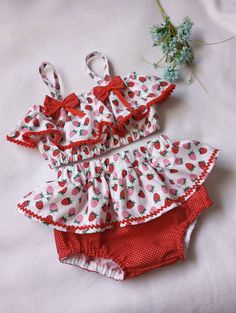 This cute little  outfit is perfect for your birthday photos.Size  12 months. Material cotton Playful Ruffled Sets For Playtime, Cute Ruffled Sets For Playtime, Cute Ruffled Sets For Playwear, Cute Ruffled Sets For Spring, Cute Ruffled Playwear Sets, Cute Fitted Summer Sets, Red Summer Birthday Sets, Sweet Pink Sets With Ruffles, Cute Pink Strawberry Print Sets