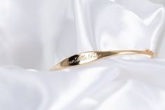 We call her perfect because once we perfected the sample for this bangle, we didn't take her off for 2 years. Fancy, but not too fancy. Just the right shape. Just the right width. The one thing you'll always wear. Solid 14k gold bangle with your name, text or bespoke design Engravable on front and inside Hand engraved to order The Perfect Bangle Sizing Small: 6.3in circumference; 52.10mm x 50.25mm diameter Medium: 6.8in circumference; 56.00mm x 54.00mm diameter Large: 7.2in circumference; 60.00m Elegant Engraved Cuff Bracelet For Formal Occasions, Elegant Engraved Cuff Bracelet For Formal, Elegant Cuff Bracelet For Promise, Elegant Engraved 14k Gold Cuff Bracelet, Elegant Engraved Bangle, Elegant Yellow Gold Cuff Bracelet For Wedding, 14k Gold Hallmarked Cuff Bracelet For Anniversary, Hallmarked 14k Gold Cuff Bracelet For Anniversary, Elegant Hallmarked Cuff Bracelet For Anniversary