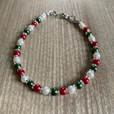 This lovely small Christmas bracelet made with glass pearls will make your Christmas Holiday season brighter!  Minimalist design features 4mm varnished glass pearls in red, green and white, a 304 stainless steel clasp, and tiny 2mm silver-lined glass beads nestled between the pearls for just the right amount of sparkle.  The classic Christmas colors are fun and festive, and it's super lightweight!    Do not wear while cleaning, bathing or swimming.  Store in a dark place, as bright light can fade the beautiful colors of the pearls. Xmas Beads, Pearl Christmas, Christmas Jewelry Gift, Bracelet Christmas, Christmas Necklace, Jewelry Making Project, Christmas Bracelet, Silver Line, Jewelry Studio