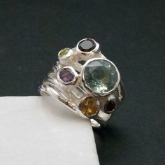 Big Multi Gemstone Statement Ring, Glamorous Wide Band 925 Silver Natural Gemstones, Blue Topaz High Fashion Ring, Fine Jewelry Gift for Her by SunSanJewelry on Etsy https://www.etsy.com/listing/475609499/big-multi-gemstone-statement-ring Multi-stone Round Fusion Jewelry, Fusion Style Multi-stone Round Jewelry, Fusion Style Round Multi-stone Jewelry, Unique Multi-stone Sapphire Ring For Anniversary, Fusion Style Oval Multi-stone Gemstones, Unique Multi-stone Sapphire Promise Ring, Unique Multi-stone Birthstone Promise Ring, Anniversary Multi-stone Round Gemstones, Fusion Style Multi-stone Jewelry For Anniversary