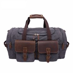 the duffel bag is grey with brown straps and two compartments on each side, one has