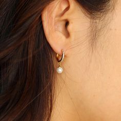 No matter where or when, these earrings are perfect. Meticulously crafted from 925 sterling silver layered with 18k gold and adorned with a pavé setting of 11 sparkling CZ Stones and a lustrous round freshwater pearl, they offer a modern take on the classic diamond earring. * Nickel free hypoallergenic for sensitive skin * Lightweight, perfect for everyday wear Details : 18k real gold layered on 925 sterling silver, cubic zirco, Natural Freshwater Pearl Diameter : 12 mm Length: 20.5 mm Width: 1.7 mm Pearl: 5mm around Elegant White Cubic Zirconia Huggie Earrings, Dainty Tarnish Resistant Pearl Earrings For Anniversary, Dainty Tarnish-resistant Pearl Earrings For Anniversary, Elegant Tarnish Resistant Huggie Pearl Earrings, Tarnish Resistant Sterling Silver Huggie Earrings For Wedding, Elegant Tarnish-resistant Huggie Pearl Earrings, White Elegant Huggie Earrings, Everyday White Cubic Zirconia Earrings, Gold Huggie Pearl Earrings In Sterling Silver