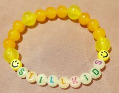 Yellow beaded bracelet, made with 8mm glass beads, two smiley's and glow in the dark letters. Made to fit average size womans wrist. Letters can be personalised. Personalized Yellow Casual Bracelet, Casual Yellow Personalized Bracelet, Casual Yellow Beaded Bracelets With 8mm Beads, Casual Yellow Beaded Bracelet With 8mm Beads, Personalized Yellow Beaded Bracelets With Round Beads, Personalized Yellow Beaded Bracelets, Casual Yellow Round Beaded Bracelets, Casual Yellow Beaded Bracelets, Casual Beaded Bracelets With Letter Beads