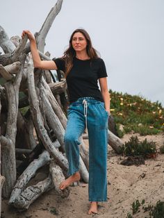 Inspired by vintage utility workwear, the Easy pant has an elastic waist with drawcord and is made of cotton and hemp making them strong, breathable and with anti-microbial properties. Easy to wear and easy on the planet. Sizing: XS: 24-25, S: 26-27, M: 28-29, L: 30-31, XL: 32-33 (if you are in between sizes, size up) Fabric: 80% Cotton, 20% Hemp. Color-way: Medium Denim Blue. Models are 5'9" and both wearing size small with a 28" inseam. Machine wash cold. Tumble dry on low. Sweat Sets, 90s Tees, Simple Tees, Elastic Waist Pants, Sweaters And Leggings, Lifestyle Shop, Waist Pants, Denim Pant, New Set