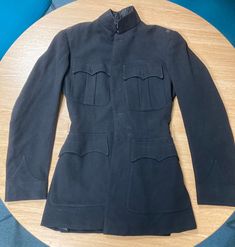 A tailor made blues (No. 1s) coat for a British Army Officer. All insignia have been removed. No. 1 Dress, or "dress blues", is a ceremonial uniform, worn on only the most formal of occasions and by senior staff officers, aides to the Royal Family, and to the personal staff of senior officers in command. It is not generally issued to all units, with the khaki No. 2 Dress functioning as the main parade uniform. Classic Formal Outerwear With Epaulettes, Navy Formal Uniform Outerwear, Vintage Navy Outerwear For Formal Events, Vintage Navy Outerwear For Formal Occasions, Fitted Peacoat With Pockets For Formal Occasions, Formal Uniform Outerwear With Epaulettes, Formal Fitted Uniform With Long Sleeves, Formal Long Sleeve Uniform, Formal Fitted Long Sleeve Uniform