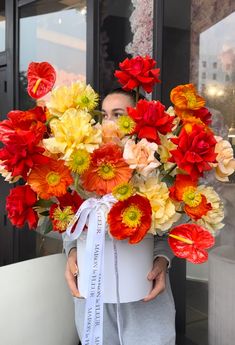 a woman holding a large bouquet of flowers