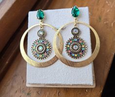 You're sure to stand out in these gorgeous and unique hoop earrings! Emerald green studs adorned with brass hoops and a jeweled middle accent. Only two pairs available! Green Jeweled Round Earrings, Green Brass Hoop Earrings, Green Small Hoop Earrings, Unique Hoop Earrings, Earrings Emerald, Brass Hoop Earrings, Brass Hoops, Garnet Gemstone, Gold Hoop