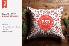 a pillow mockup with pine branches and berries on the wood background, ready to be printed