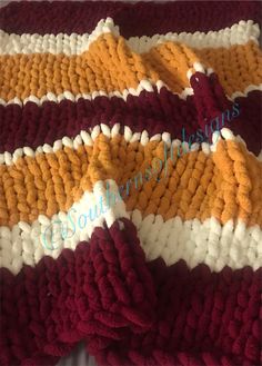 a crocheted blanket that is laying on the floor with it's edges folded down