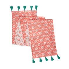 two red and white napkins with green tassels