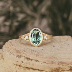 a green ring sitting on top of a rock