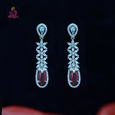 These American Diamond Floral Dangle Drop Earrings are a beautiful and versatile. The earrings feature a delicate floral design, with sparkling American Diamonds arranged in a stunning pattern. The main attraction of these earrings is the color CZ oval stones, which add a touch of glamour and elegance. The dangle style of the earrings gives them a fun and flirty vibe, making them perfect for both casual and formal occasions. They are made with high-quality materials and are designed to last, so Main Attraction, Kundan Necklaces, Cz Jewelry, Oval Stone, American Diamond, Indian Design, Stone Necklace, Stone Jewelry, Stone Color