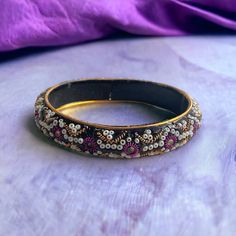 Vintage glittery, sparkly, bangle bracelet. Good condition. Unsigned/unknown maker. Measurements shown in the pics. Thanks for looking! Adjustable Purple Bangle For Festive Occasions, Purple Bangle Bracelets For Festivals, Purple Bracelets For Festivals And Gifts, Gold Beaded Bangle Bracelet For Party, Festival Party Beaded Bangle, Purple Beaded Bangle Bracelets For Party, Beaded Bangle For Party, Festive Beaded Bangle, Festive Beaded Round Bangle