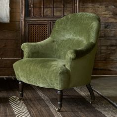 a green chair sitting on top of a wooden floor