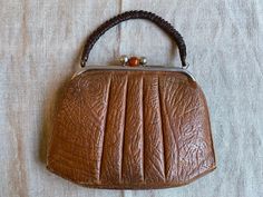 "Adorable vintage 40s 50s brown leather handbag for women. Measures - height - 24cm (9.4\") width - 31cm (12.2\") In good vintage condition, inside canvas is damaged from one side and outside bottom corners need fixing. Real colours may be little different from their appearance on your display. Pleas look at the pictures carefully and i will be happy to answer all of your questions. Feel free to visit my shop for other vintage goods: www.etsy.com/shop/SkySecrets" Vintage Cognac Satchel Bag, Antique Brown Bags For Formal Occasions, Brown Evening Bag With Rolled Handles, Retro Brown Formal Bags, Vintage Brown Rectangular Bag, Vintage Brown Satchel Bag, Retro Vintage Brown Shoulder Bag With Leather Handles, Retro Satchel With Leather Handles, Vintage Shoulder Bag With Leather Handles