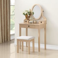 a wooden vanity table with a mirror and stool