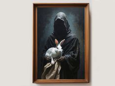 a painting of a nun holding a rabbit in front of a dark background with a wooden frame