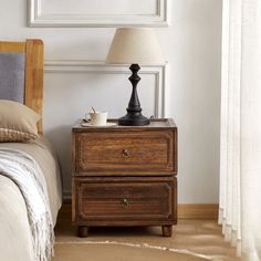 This nightstand brings a touch of farmhouse charm and transitional style to your bedroom. Crafted from kiln-dried solid paulownia wood, it features a stacked, rectangular shape with a finished back, ensuring it looks great from every angle. The two drawers glide smoothly on roller glides, offering easy access to your bedside essentials. Antique bronze ring handles add a vintage touch, complementing the rustic appeal of the paneled drawer fronts. With its versatile design, this nightstand can als Metal And Glass Nightstand, Dark Wooden Nightstand, Dresser As Bedside Table, Chunky Nightstand, Bedroom Night Stand Decor, Cozy Masculine Bedroom, Dresser And Night Stand Set, Cape Interior, Bedroom Transitional Style