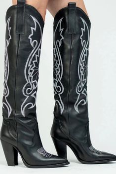 We now give you a stunning knee-high black leather western boot. With its bold and edgy design, captures the essence of Western style with a contemporary twist. Crafted from premium black leather, these knee-high boots exude confidence and sophistication. The intricate western-inspired details, like the pointed toe and stacked heel, add a touch of rugged charm. Whether you're heading to a music festival or stepping out in the city, this boot is the perfect companion for making a bold fashion sta Wedding Guest Romper, Party Bottoms, Edgy Design, Leather Western Boots, Denim Romper, Western Boot, Black Leather Heels, Maxi Dress Party, Western Dresses