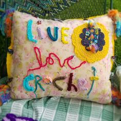 a decorative pillow with the words live love and laugh on it sitting on a chair