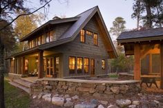 a house that is made out of wood and has stone steps leading up to it