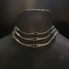 "Lead-free pewter cast chicken bone chokers. Each bone bar is 4\" x ¼\" Adjustable 14\" - 16\" See this listing for interchangeable pendant versions. https://www.etsy.com/listing/1204160736/bone-chokers-with-interchangeable?click_key=cc61314a71a59c20aee60a000413187b23f41fbe%3A1204160736&click_sum=a9392cb3&ref=shop_home_active_1&frs=1 Always ethically sourced bones. Nothing has ever been harmed for the purpose of our jewelry. All pieces are made-to-order despite the \"in stock\" number in the lis Pewter Casting Jewellery, Animal Bone Jewelry Wire, Bone Jewelry Aesthetic, Unique Metal Clavicle Chain Choker, Unique Metal Choker With Adjustable Chain, Nickel Free Punk Style Choker, Adjustable Silver Stainless Steel Choker, Adjustable Stainless Steel Silver Choker, Bone Colored Metal Jewelry Gift