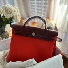 Authentic With Receipt. Herbag Zip 31 Bag Color: Orange Mcano/Rouge H Measurements Width:9.8 In Height:12.2 In Depth:3.9 In Brand New With Original Tags, Box, Dust Bag And Receipt. High-end Red Shopping Bag, High-end Red Shoulder Bag, High-end Red Bag With Detachable Handle, High-end Red Bag With Removable Pouch, High-end Red Shoulder Bag With Detachable Handle, High-end Red Shoulder Bag With Double Handle, Luxury Red Bags For Daily Use, Luxury Red Top Handle Bag, High-end Red Shoulder Bag With Top Carry Handle