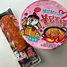 a hot dog on a stick next to a package of ramen noodles