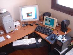 a computer desk with two computers on top of it and other electronic equipment around the desk