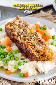 meatloaf with mashed potatoes and peas on a plate