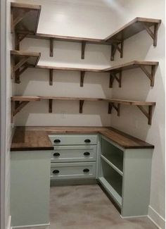 an empty room with some shelves and drawers