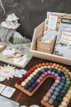 a wooden box filled with crayons and other crafting supplies sitting on top of a table