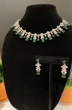 Beautiful and elegant Choker with high quality stones. Comes with a pair of matching earrings in silver and emerald finish. Can pair well with any outfit or dress for a night out! The green stone is amazing quality and is such a beautiful tone. Wedding Silver Emerald Necklace With Cubic Zirconia, Wedding Silver Emerald Cubic Zirconia Necklace, Party Emerald Cut Emerald Jewelry, Green Gemstone Jewelry Sets For Wedding, Silver Emerald Bridal Necklace In Fine Jewelry Style, Hand Set Emerald Necklace For Reception, Elegant Silver Emerald Necklace For Reception, Wedding Green Gemstone Jewelry Set, Green Fine Jewelry Bridal Necklace