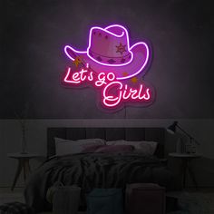 a neon sign that says let's go girls with a cowboy hat on it