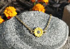 "This bracelet is perfect for anyone! You can choose a yellow sunflower or a white daisy. The metal is a gold color. The flower measures 1/2\" wide. The bracelet has an extender on it so it is adjustable, and it has a heart charm at the end. Perfect for a Mom gift, for a Christmas gift, anniversary, or a birthday. All jewelry items come in a gift box." Dainty Yellow Bracelet For Gift, Dainty Yellow Bracelet As Gift, Yellow Bracelets With Flower Charm For Gift, Adjustable Yellow Jewelry Gift, Adjustable Yellow Jewelry As A Gift, Gold Bracelet With Birth Flower Design, Personalized Gold Flower Bracelets, Gold Bracelet With Birth Flower For Gift, Petoskey Stone