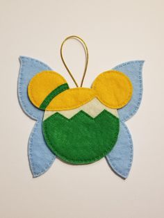 an ornament made to look like a flower with yellow and blue petals on it