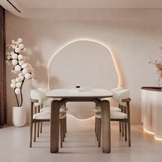 a white dining room table surrounded by chairs and vases with flowers on them in front of a circular light fixture